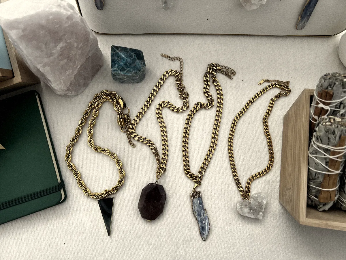 Four necklaces from the first run laid flat on the market table